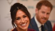 In this file photo taken on October 25, 2019 Britain's Prince Harry, Duke of Sussex (R) and Meghan, Duchess of Sussex attend a roundtable discussion on gender equality with The Queen’s Commonwealth Trust (QCT) and One Young World at Windsor Castle in Wind