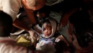 An injured child receives medical treatment after an earthquake in Port-au-Prince in this January 13, 2010 file photo. Reuters/Eduardo Munoz