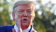 Donald Trump speaks to the press after announcing and initial deal with China at the South Lawn of the White House on October 11, 2019. AFP / Nicholas Kamm