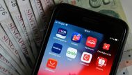 This illustration photograph taken on January 9, 2020 shows banking and purchasing apps on a smartphone in Singapore. AFP / Roslan Rahman 