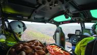 NSW's National Parks and Wildlife Service staff fly with carrots and sweet potatoes before air-dropping them for animals in bushfire-stricken areas around Wollemi National Park, New South Wales, Australia January 10, 2020. NSW DPIE Environment, Energy and