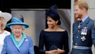 In this file photo taken on July 10, 2018 (L-R) Britain's Queen Elizabeth II, Meghan, Duchess of Sussex, Britain's Prince Harry, Duke of Sussex stand on the balcony of Buckingham Palace in London to watch a military fly-past to mark the centenary of the R