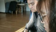 South Korean parents Lee Young-tae (left) and Jeong Hee-ho (right) look at the photo of their daughter, who took her own life after she was filmed secretly in a so-called spycam porn case, during an interview at their home in Gimhae, South Korea December 
