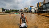 Man carries his belongings across floodwaters at the Jatinegara area after heavy rains in Jakarta, Indonesia, January 2, 2020. Reuters/Willy Kurniawan