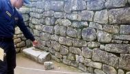 Handout image distributed by the Peruvian Police of a policeman showing a rock dislodged by a group of foreign tourists when trespassing to the ancient Inca citadel of Machu Picchu, Peru, on January 12, 2020/ AFP / Peruvian National Police /