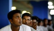 Foreign workers from Bangladesh wait at an airport carpark turned into an immigration depot in Sepang September 20, 2007. Reuters/Bazuki Muhammad