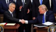 Chinese Vice Premier Liu He and US President Donald Trump shake hands after signing 