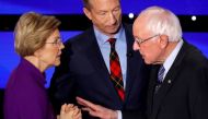 FILE PHOTO: Democratic 2020 U.S. presidential candidates (L-R) Senator Elizabeth Warren (D-MA) speaks with Senator Bernie Sanders (I-VT) as billionaire activist Tom Steyer listens after the seventh Democratic 2020 presidential debate at Drake University i