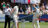 South Africa's Dane Paterson (R) delivers a ball to England's Dom Sibley as England's Zak Crawley (C) and umpire Bruce Oxenford (L) looks on during the first day of the third Test cricket match between South Africa and England at the St George's Park Cric