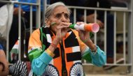 In this file photo taken on July 9, 2019, India's cricket team supporter, 87 year old Charulata Patel cheers on her team during the 2019 cricket World Cup first semi-final between India and New Zealand / AFP / Oli SCARFF /
