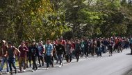 Honduran migrants walk near Esquipulas, Chiquimula departament, Guatemala, on January 16, 2020, after crossing the border in Agua Caliente from Honduras on their way to the US. AFP / Johan Ordonez
 