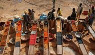 Artisanal miners sluice for gold by pouring water through gravel at an unlicensed mine near the city of Doropo, Ivory Coast, February 13, 2018. Reuters/Luc Gnago