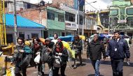 Tourists being escorted by authorities as they walk towards the borderline with Bolivia in Desaguadero, Peru, on January 16, 2010, after they were arrested for surreptitiously entering prohibited areas of the ancient Inca citadel of Machu Picchu, and dama