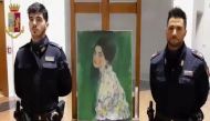 Police officers standing by a painting stolen over 20 years ago and which by initial indications was painted by Gustav Klimt found by chance in Piacenza museum gardens in northern Italy AFP Polizia Di Stato (Italian State Police video grab on December 12,