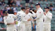 England's Dominic Bess (C) celebrates with teammates after the dismissal of South Africa's Rassie van der Dussen during the third day of the third Test cricket match between South Africa and England at the St George's Park Cricket Ground in Port Elizabeth