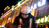 Liu Pengfei, a substitute driver of DiDi Chuxing, checks the ride-hailing app before starting his night shift in Beijing, China January 10, 2020. REUTERS/Thomas Peter