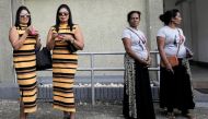 Lakshika and Devika (55), look on during an event to attempt to break the world record for the biggest gathering of twins in Colombo, Sri Lanka January 20, 2020. Reuters/Dinuka Liyanawatte
 
 
