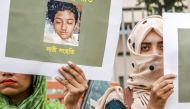 Bangladeshi women hold placards and photographs of schoolgirl Nusrat Jahan Rafi at a protest in Dhaka following her murder after she had reported a sexual assault on April 12, 2019. AFP  / Sazzad Hossain