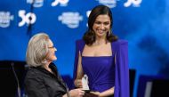 Indian actress Deepika Padukone (R) receive a trophy from Hilde Schwab, Chairwoman and Co-Founder of the World Economic Forum's World Arts Forum during the