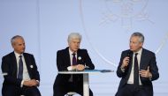 French Economy and Finance Minister Bruno Le Maire (R) delivers a speech next to Arnaud Vaissie (C) CEO and co-founder of medical and travel security services firm, International SOS and Olivier Schiller (L), CEO of Septodont during a gathering of 500 bus