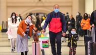 Commuters wearing face masks walk in Hankou railway station in Wuhan, in China's central Hubei province on January 21, 2020. Asian countries on January 21 ramped up measures to block the spread of a new virus as the death toll in China rose to six and the