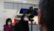 Passengers who arrived on one of the last flights from the Chinese city of Wuhan walk through a health screening station at Narita airport in Chiba prefecture, outside Tokyo, on January 23, 2020, as countries screen for anyone showing symptoms of a SARS-l