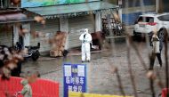 FILE PHOTO: A worker in a protective suit is seen at the closed seafood market in Wuhan, Hubei province, China January 10, 2020. Reuters/Stringer/File Photo CHINA OUT.