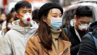 Pedestrians are seen wearing a surgical masks in London's China Town on January 25, 2020. AFP / Niklas Halle'n