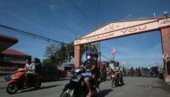 Residents on motorcycles ride back to their homes after the Philippine volcanology bureau lowered the alert level from 4 to 3 and residents were allowed to return home in the town of Lemery, Batangas province, south of Manila on January 26, 2020. A major 