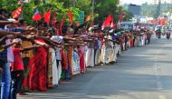 People line up along a road to form a 620 km human chain across the southern state of Kerala organized by the Left Democratic Front (LDF) to protest against the Indian government's Citizenship Amendment Act (CAA), Thiruvananthapuram on January 26, 2020. A