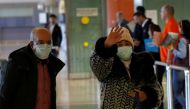 Tourists from Morocco wear masks to prevent contracting coronavirus at the Malaga-Costa del Sol airport, in Malaga, southern Spain January 29, 2020. REUTERS/Jon Nazca