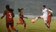 In this file photo taken on January 04, 2017 India's Ngangom Bala Devi (R) fights for the ball with Bangladesh players during the final of the South Asian Football Federation (SAFF) women's football championship at the Kanchanjungha Stadium in Siliguri./ 