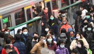 Mask-clad commuters get off a train at a Mass Rapid Transit (MRT) stop in Taipei following the Lunar New Year holidays on January 30, 2020. / AFP / Sam Yeh