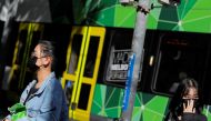  People wearing face masks walk on Bourke Street after cases of the coronavirus were confirmed in Melbourne, Victoria, Australia, January 29, 2020. REUTERS/Andrew Kelly 