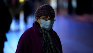 A woman wearing a mask is seen on a street in Shanghai, China January 31, 2020. REUTERS/Aly Song