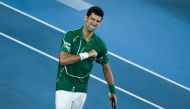 Serbia's Novak Djokovic celebrates his victory against Switzerland's Roger Federer during their men's singles semi-final match on day eleven of the Australian Open tennis tournament in Melbourne on January 30, 2020. (AFP / Saeed Khan)