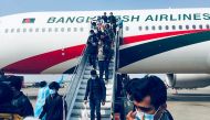Bangladeshi nationals disembark from a Biman Bangladesh Airlines' plane at the tarmac of Hazrat Shahjalal International Airport following their evacuation from the Chinese city of Wuhan, in Dhaka on February 1, 2020. A virus similar to the SARS pathogen h