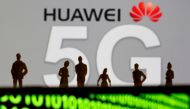 Small toy figures are seen in front of a displayed Huawei and 5G network logo in this illustration picture, March 30, 2019. Reuters / Dado Ruvic