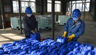 This photo taken on January 30, 2020 shows workers producing disinfectant at a factory in Xiaogan in China's central Hubei province, to support the supply of medical materials during the virus outbreak in Hubei's city of Wuhan. / AFP / STR 