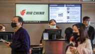 Chinese citizens wear face masks to protect against the spread of the Coronavirus as they check in to their Air China flight to Beijing, at Los Angeles International Airport, California, on February 2, 2020. AFP / Mark Ralston 