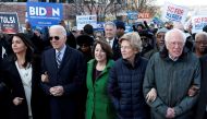 Tulsi Gabbard, Joe Biden, Amy Klobuchar, Elizabeth Warren and Bernie Sanders, walk arm-in-arm with during the MLK Day Parade in Columbia January 20, 2020. Reuters / Randall Hill