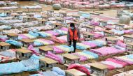 A worker sets up beds at the Hongshan Stadium to convert it into a makeshift hospital following an outbreak of the new coronavirus, in Wuhan, Hubei province, China February 4, 2020. China Daily via REUTERS 