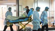 Medical staff transfer a patient of a suspected case of a new coronavirus at the Prince of Wales Hospital in Hong Kong, January 22, 2020. (cnsphoto via Reuters)