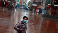 A man wearing a face mask walks in a deserted shopping area in Jiujiang, Jiangxi province, China, as the country is hit by an outbreak of the novel coronavirus, February 2, 2020. Reuters / Thomas Peter