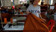 A woman sews a robe made of plastic bottles at a monastery in Bangkok, Thailand February 6, 2020. REUTERS/Soe Zeya Tun