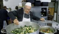 Dino Impagliazzo, Rome's 90-year-old 'chef of the poor', stirs a saucepan of soup which he cooks for the homeless living in Rome and outside the Vatican colonnades, in Rome, Italy, January 18, 2020. Picture taken January 18, 2020. REUTERS/Remo Casilli