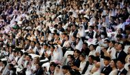 Couples wearing masks for protection from the new coronavirus, attend a mass wedding ceremony of the Unification Church at Cheongshim Peace World Centre in Gapyeong, South Korea, February 7, 2020. REUTERS/Heo Ran