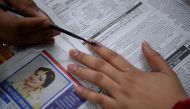An election officer marks the finger of a voter at a polling station during the Legislative Assembly elections in New Delhi on February 8, 2020. / AFP / Sajjad HUSSAIN 