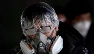 A passenger wearing a mask walks outside the Shanghai railway station in Shanghai, China, as the country is hit by an outbreak of the novel coronavirus, February 8, 2020. REUTERS/Aly Song 