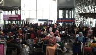  Passengers wear protective face masks at Kuala Lumpur International Airport in Sepang on February 4, 2020. / AFP / Mohd RASFAN